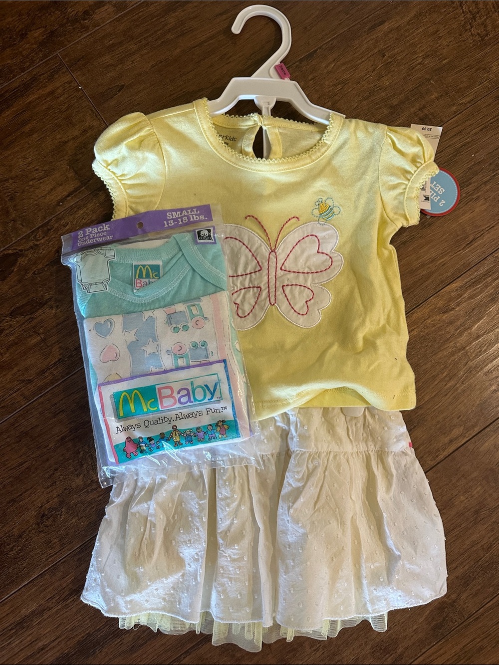 Yellow Butterfly Baby Top with White Ruffle Skirt and package of vintage onesies